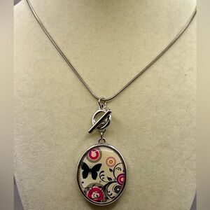 Silver and Pink Reversible Floral Pendant Necklace with a toggle front. 20 inch